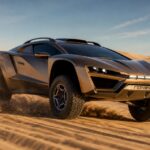 Bronze Rezvani Dune off-road supercar driving across desert sand