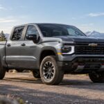 Gray Chevrolet Silverado pickup at a mountain overlook